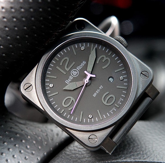 The pink second hand is striking on the gray-toned dial.